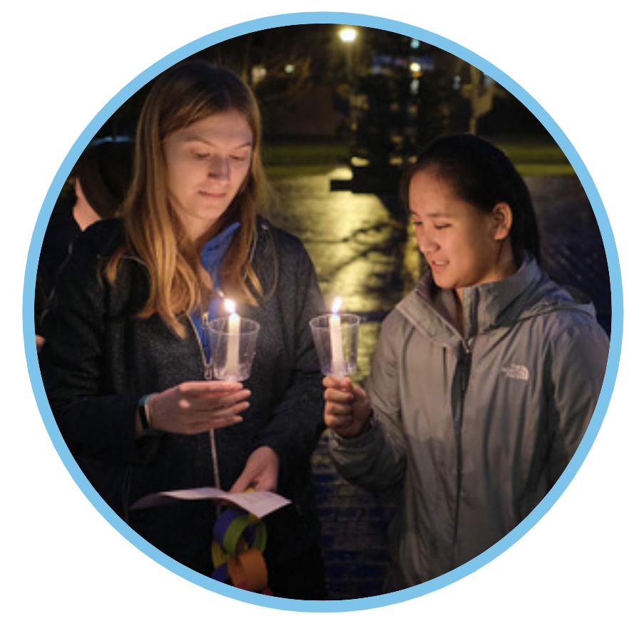 Students holding candles in Red Square at night